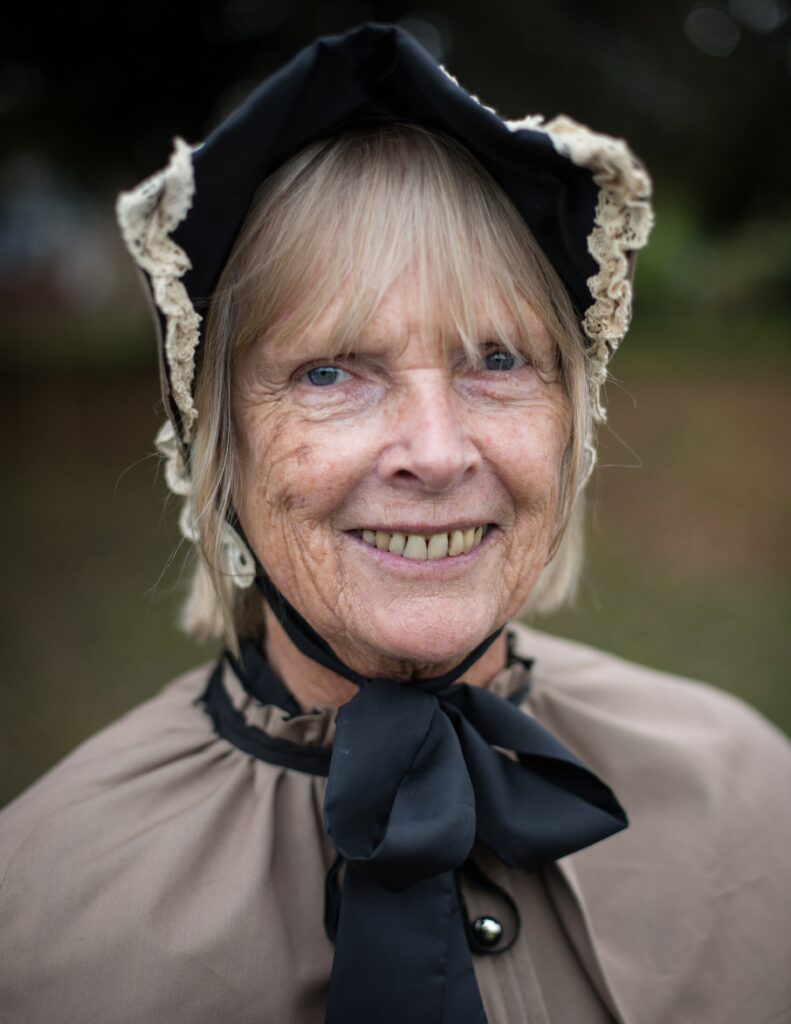 older woman wearing a french bonnet